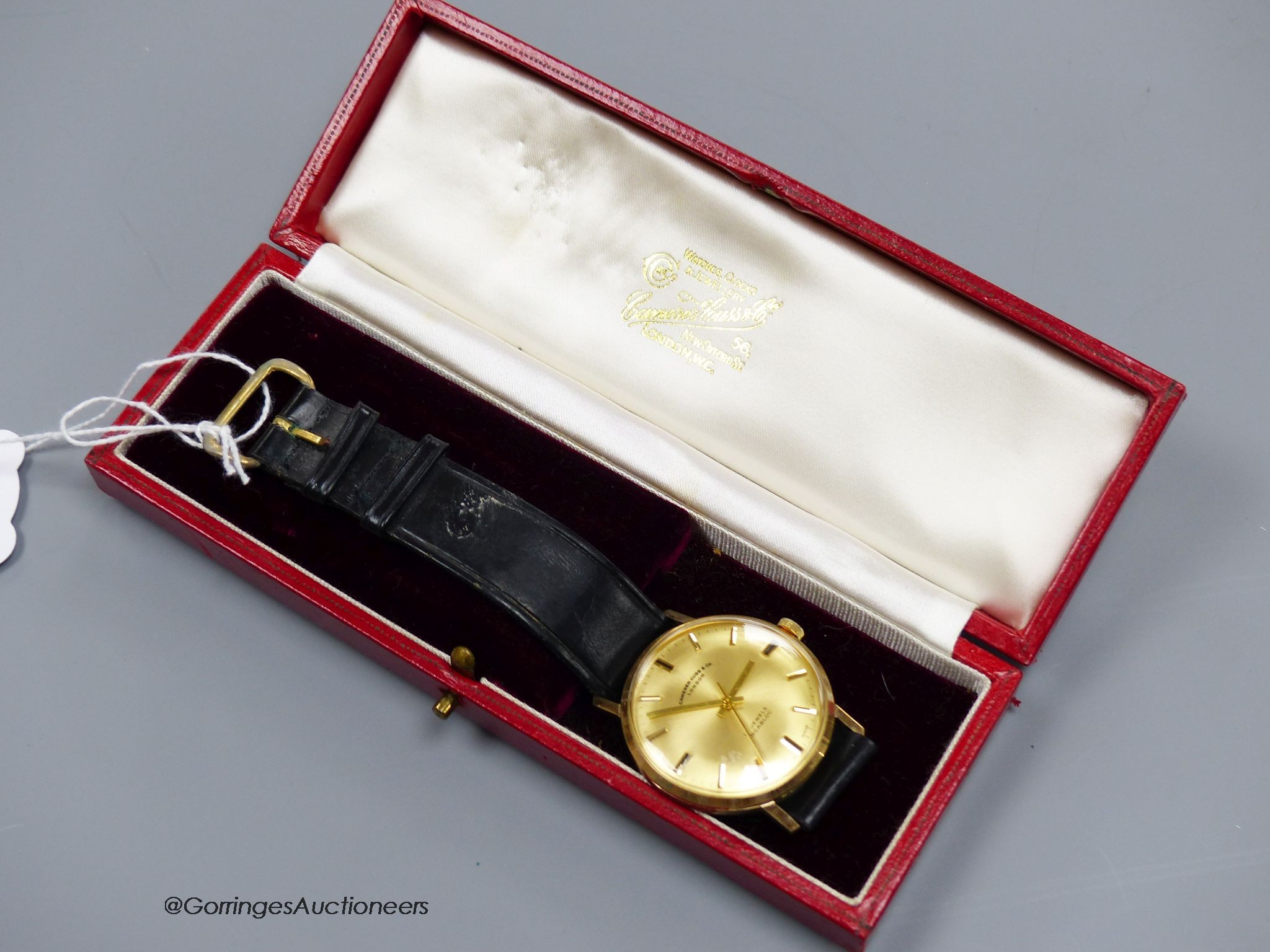 A gentleman's 9ct gold-cased wristwatch retailed by Camerer Cuss & Co, on leather strap, boxed